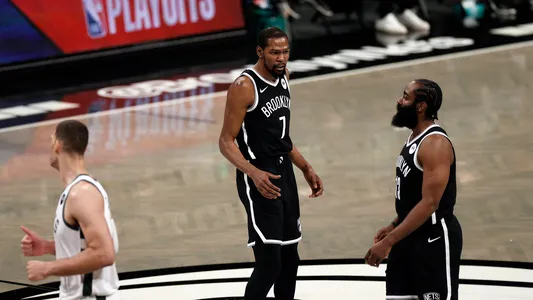 Brooklyn Nets guard James Harden walks off the court past Kevin Durant as he exits the court early during the first quarter against the Milwaukee Bucks, Saturday, June 5, 2021