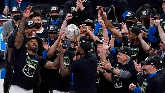 The Milwaukee Bucks celebrate with the conference trophy after defeating the Atlanta Hawks in Game 6 of the Eastern Conference finals in the NBA basketball playoffs, Saturday, July 3, 2021, in Atlanta